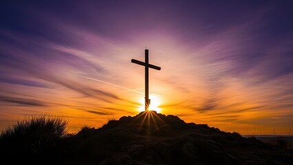 Cross silhouette against a vibrant sunset sky, symbolizing faith and hope on a hilltop