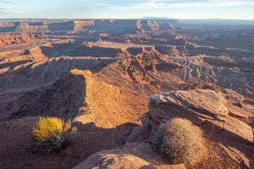 Dead Horse Point State Park in San Juan County, Utah, dramatic view of the Colorado River and Canyonlands National Park in Utah, Page, USA. Deserts, rocks, ledges, and mountains. Beautiful sunset