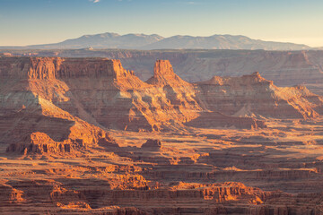 Dead Horse Point State Park in San Juan County, Utah, dramatic view of the Colorado River and Canyonlands National Park in Utah, Page, USA. Deserts, rocks, ledges, and mountains. Beautiful sunset