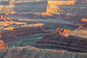 Dead Horse Point State Park in San Juan County, Utah, dramatic view of the Colorado River and Canyonlands National Park in Utah, Page, USA. Deserts, rocks, ledges, and mountains. Beautiful sunset