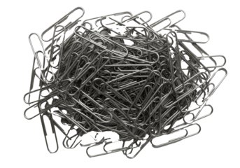 A dense, chaotic pile of polished silver metallic paper clips in a macro top-down view on a transparent background with copy space. Office supplies concept