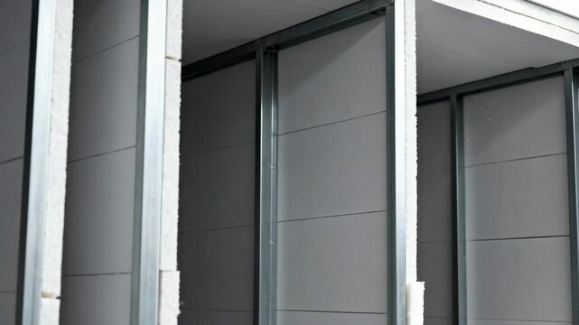 Medium shot of structural advanced Polyiso panels focusing on sturdy composition supporting loadbearing walls with superior insulation.