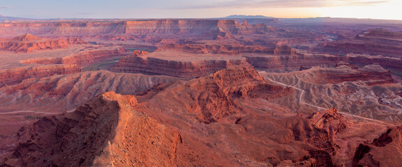 Dead Horse Point State Park in San Juan County, Utah, dramatic view of the Colorado River and Canyonlands National Park in Utah, Page, USA. Deserts, rocks, ledges, and mountains. Beautiful sunset