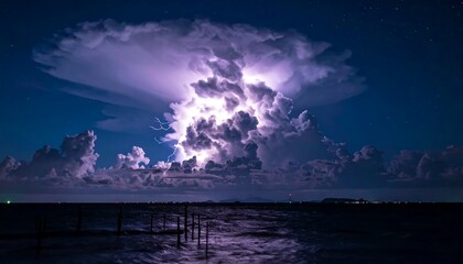 Striking lightning illuminates towering storm clouds over a calm, dark sea with pier remains