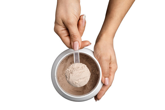 Top view of female hand holding measuring scoop with chocolate whey protein powder above plastic jar, isolated on transparent background, concept of sports nutrition and dietary supplements