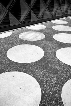 Urban architecture pavement pattern with circular geometry, abstract minimalism and modern exterior design emphasizing graphic architectural detail