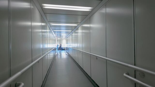 Empty modern airport jet bridge with sleek design and ambient lighting creates a futuristic and tranquil atmosphere in the airport setting