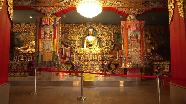 Golden Buddha Idol in Traditional Tibetan Buddhist Monastery Interior.
