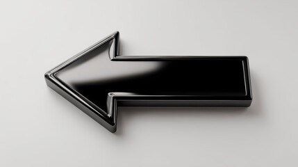 A glossy black arrow pointing left on a white surface, creating a simple and graphic illustration. This image emphasizes direction