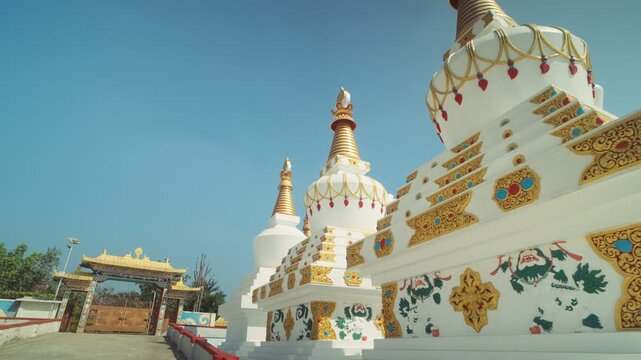 Sacred Buddhist Stupas and Temple Gate in Bright Daylight