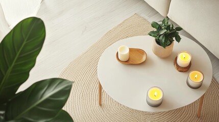 Serene living space featuring white coffee table with lit candles, potted plant, and decorative items. Modern interior design with natural elements and warm ambiance