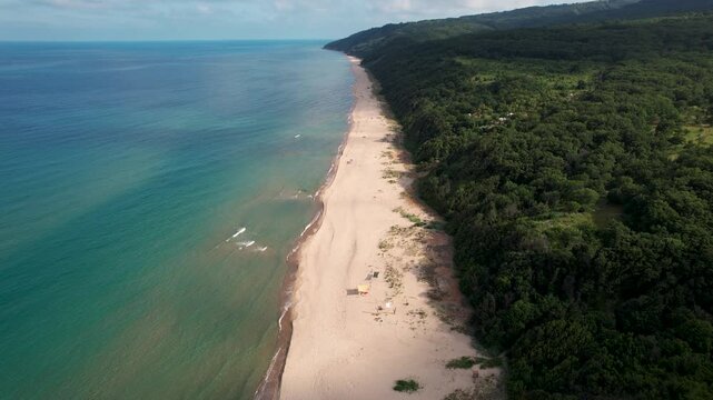 Aerial view of the Vaya Beach coastline featuring the contrast between the  deep blue sea and the golden sands meeting the lush green forest, Vaya  Beach, Emona, Bulgaria.