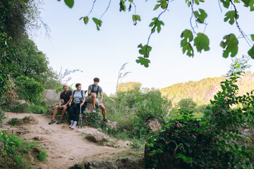 Family enjoying a hiking rest on nature trail