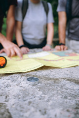 Hikers planning adventure route using map and compass