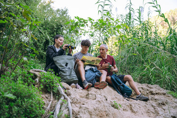Family hiking exploring nature with map and binoculars