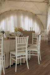 Elegant wedding reception table setup with chiavari chairs