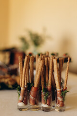 Breadsticks wrapped in prosciutto served as appetizers