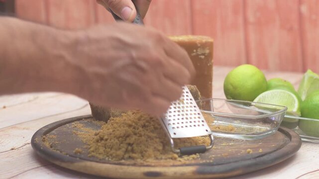 Man Grating Traditional Panela Cane Sugar Kitchen