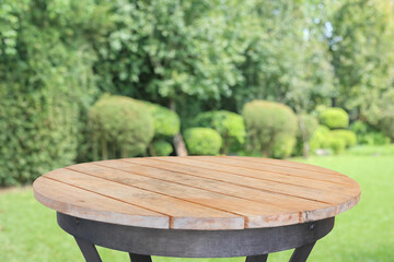 Fototapeta premium Empty round wood table top with abstract blur park garden background