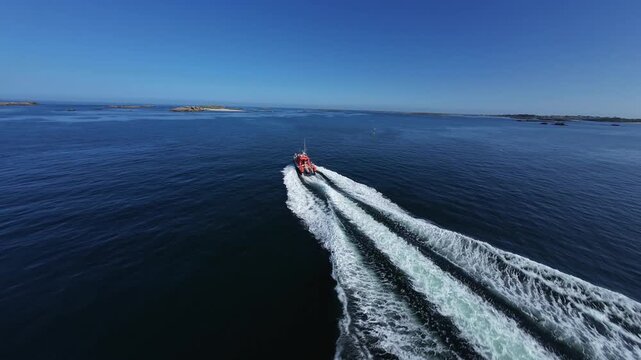 Cinematic FPV drone shot of SNSM rescue boat on mission, maritime safety, sea rescue, emergency response