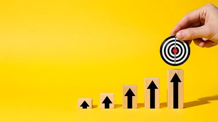 A hand placing a target on top of growing arrows on a yellow background