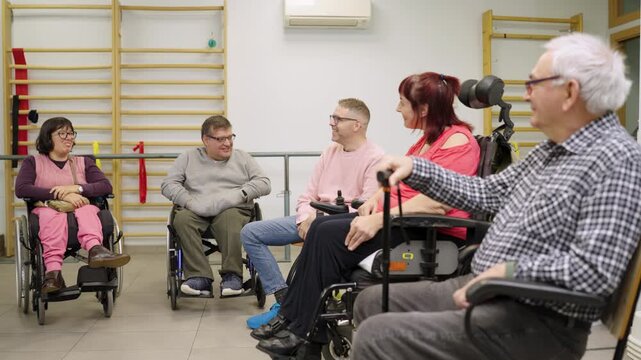 Diverse group of people with disabilities sitting in a circle during a therapy session in a rehabilitation center. Social inclusion concept