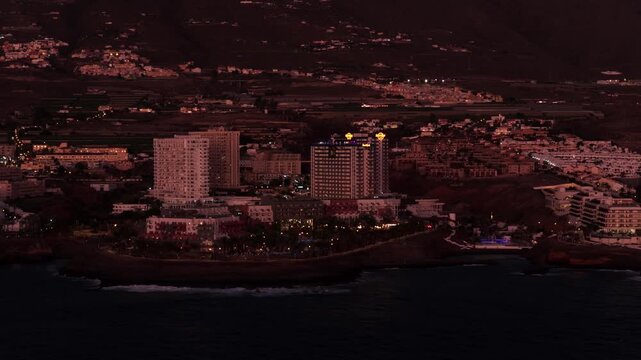 Aerial night view of illuminated coastline and waterfront in Tenerife, Canary Islands



