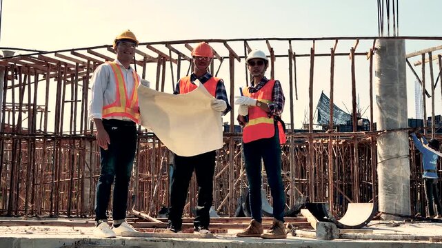 Structural engineer, architect and foreman worker with blueprints discuss, plan working for the outdoors building construction site. Construction collaboration concept. 4K