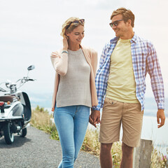 Obraz premium Holding hands, travel and road trip with couple outdoor for honeymoon, holiday and love. Bonding, summer vacation and date with man and woman with scooter for happiness, transportation and walking