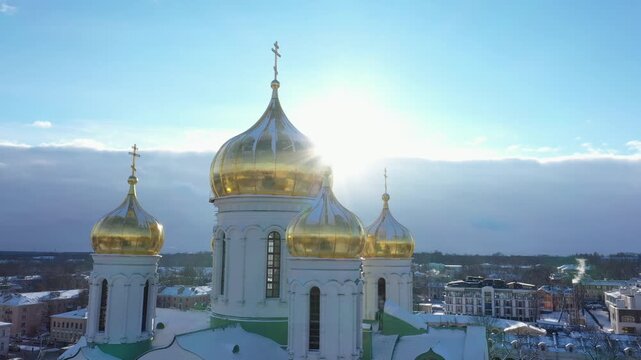 Majestic golden domes of Catherine Cathedral in Pushkin with winter city background under blue sky