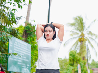 Fitness woman enjoying light exercise at park in holiday. Female workout stretching routine in vacation. Healthy lifestyle people wellness. People exercise new year motivation focus transformation