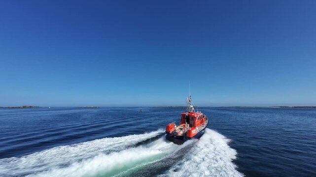 High-speed FPV drone chase shot following a rescue boat at sea  cinematic maritime action footage. Immersive FPV chase shot following a rescue boat at high speed across open water. 