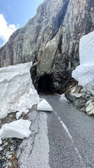 Mountain Road Tunnel Entrance with Melting Snow Drifts