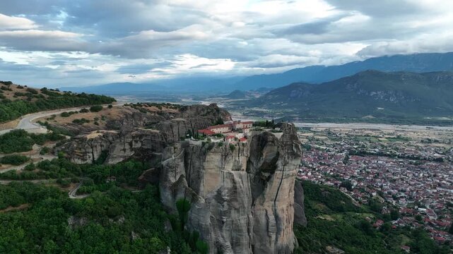 Aerial view of the iconic Meteora Monastery perched atop towering cliffs, a surreal landscape blending nature's grandeur with human spirituality, Meteora, Greece.