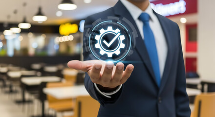 Businessman holding holographic gear with check mark symbolizing technology and approval