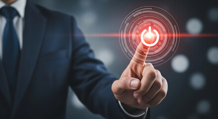 Man in suit touching glowing power button technology activation and innovation