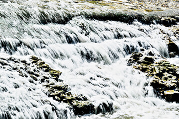 Water cascading over the rocks with a silky effect	