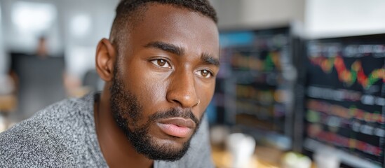 Black Male Entrepreneur Analyzing Stock Charts for Business Growth