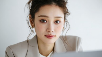 Japanese Businesswoman Taking Notes During Virtual Team Meeting