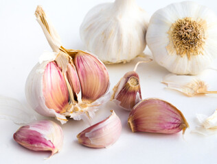 garlic heads and cloves on white background
