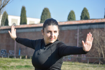 Woman with visual disabilities exercising in the park and stretching