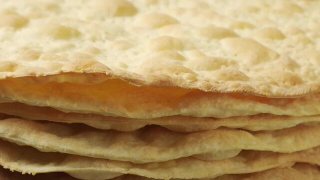 Stack of Baked Cake Layers Rotating: Close-up of crispy golden puff pastry crusts for traditional Napoleon cake or mille-feuille dessert