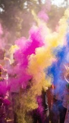 Fototapeta premium Multicolored powder clouds at lively outdoor celebration.