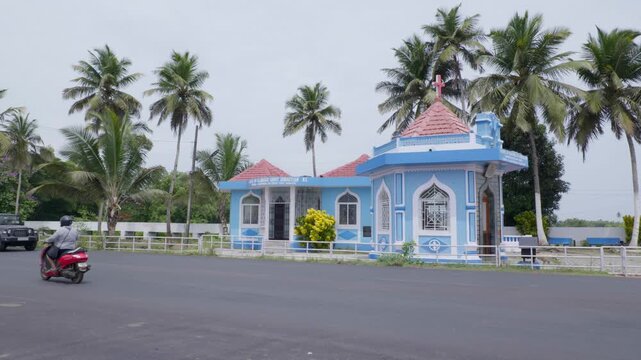 Chinchinim, Goa, India - May 20th 2024 - Shot of vehicles passing by Chapel of Glorious Saint Sebastian Nx.