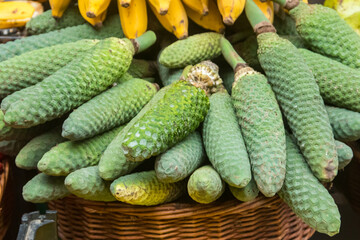 Delicious exotic fruits of Monstera deliciosa (banana pineapple, banana ananas or ceriman) on traditional farmer market in Funchal, Madeira, Portugal