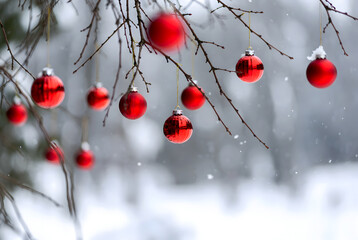 Christmas toys hanging on a snowy fir branch