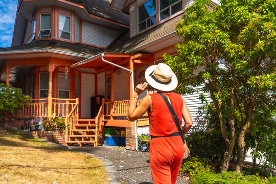 Tourist walking near colorful wooden house in chemainus, vancouver island - Powered by Adobe
