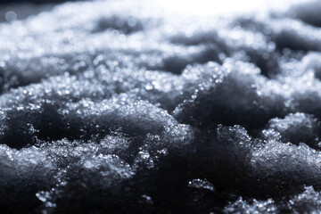 Snow close-up on a dark background. melting ice. 