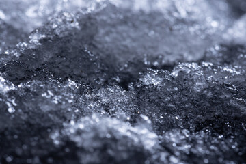 Snow and ice close-up on a dark background. Abstract winter background.