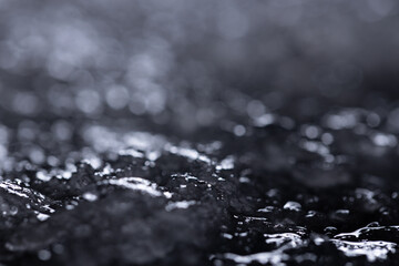 Snow and ice close-up on a dark background. Abstract winter background.